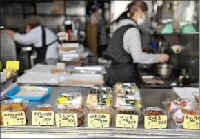  ?? AFP ?? Food displayed for sale at a restaurant in Tokyo’s Sunamachi area.