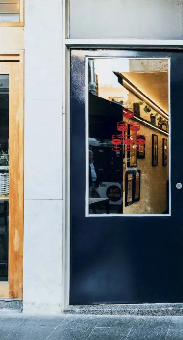  ??  ?? Right — Restrained terrazzo panels in alabaster and French navy are the only clues that the old dry cleaner’s shop has found a new purpose. Photograph­y: Lewis Potter.