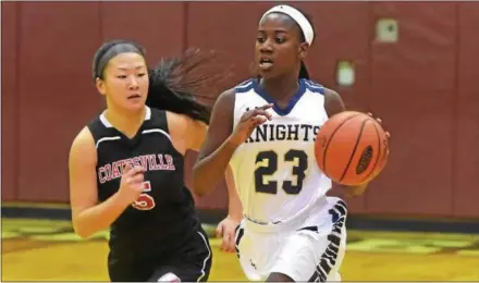  ?? PETE BANNAN — DIGITAL FIRST MEDIA ?? Coatesvill­e junior Sarah Huston (5) defends as Rustin’s Dakiya Daniels (23) moves up court in the first half of the Ches-Mont Challenge opener Friday evening at Henderson.