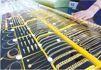  ?? Yonhap ?? A collection of gold rings, necklaces and bracelets are on display at a jewelry store in Seoul, Sunday.