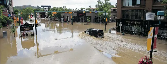  ?? PHOTOS: STUART GRADON/ POSTMEDIA NEWS FILES ?? ONE YEAR AGO: A police van drives through the flooded intersecti­on of 4th Street and 24th Avenue S. W. in Calgary on June 22, 2013.