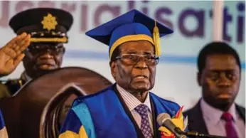  ?? AFP/GETTY IMAGES ?? Although the military arrested President Robert Mugabe on Wednesday, he was allowed to deliver a speech on Friday during a graduation ceremony at the Zimbabwe Open University in Harare, where he is chancellor.