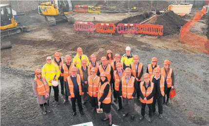  ??  ?? Launch Councillor Tweed, watched by other guests, performs the ground-breaking ceremony at the developmen­t site