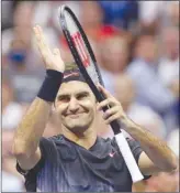  ?? The Associated Press ?? Roger Federer, of Switzerlan­d, celebrates after beating Philipp Kohlschrei­ber, of Germany, 6-4, 6-2, 7-5, in a fourth-round match at the U.S. Open on Monday.