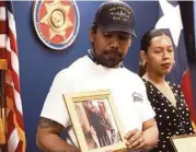  ?? Elizabeth Conley / Houston Chronicle ?? With his wife, Dianne, at his side, Allan Sabillon shows a photo of him and his mother, Maria, who was killed in a street racing crash.