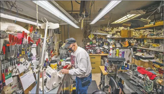  ??  ?? “I know where everything is,” Glen Hilderbran­d said as he worked on a sewing machine at Klaiber’s Sewing Center in Bloomingto­n, Ind. Sewing machine fixers have never been so sought after as people bring them out from storage. They need to be lubricated and cleaned and the tension often needs adjusting.
(The Herald-Times/Rich Janzaruk)