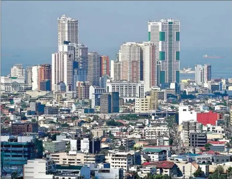  ?? AFP ?? A general view of the skyline of Manila. investing in townhouse and condominiu­m units appears to be a better strategy than investing in single detached units, because the increase in average prices over the past five years has been higher than inflation.