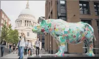  ??  ?? A black rhino sculpture painted by Zhang Huan, near St Paul’s Cathedral, London.