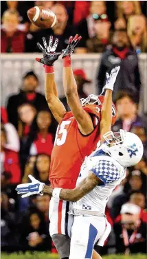  ?? CURTIS COMPTON / CCOMPTON@AJC.COM ?? Cornerback Aaron Davis, intercepti­ng a pass intended for Kentucky’s Garrett Johnson during his last game in Athens, earned a scholarshi­p in 2015 after coming back from knee injuries in his last two years of high school.