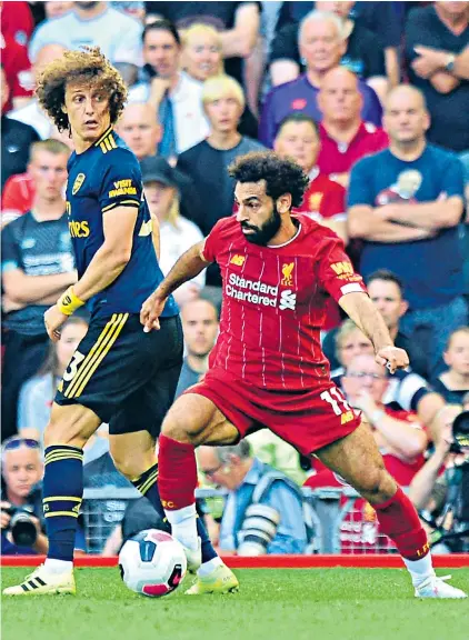  ??  ?? Double take: David Luiz can only watch as Mohamed Salah leaves him trailing in his wake