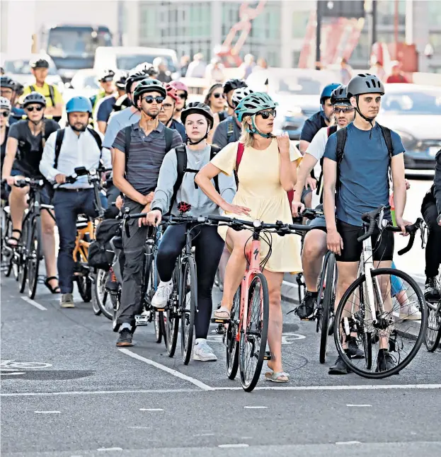  ?? ?? Commuters took to their bikes in Vauxhall, London, yesterday as train services continued to be disrupted; passengers waiting for Stratford station to open; Clapham Junction station remained closed after the strike until 7.30am