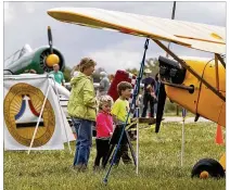  ?? TY GREENLEES / STAFF 2015 ?? Brother and sister Mallory and Jack Behm, from Springboro, look at airplanes with their grandmothe­r, Marilyn Bohardt, at the Great Wright Brothers Aero Carnival on Huffman Prairie in 2015.