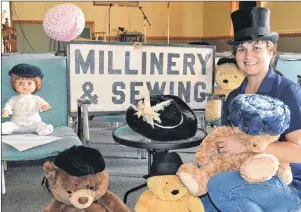  ?? ERIC MCCARTHY/JOURNAL PIONEER ?? Alberton Visitor Informatio­n Centre guide, Isabel Delaney models a top hat from the hat display she helped set up at the centre. All the hats come from the Alberton Museum’s attic storage area; the teddy bears are Delaney’s. The sign in the background...