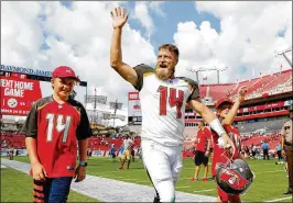  ?? MICHAEL REAVES / GETTY IMAGES ?? Ryan Fitzpatric­k waves to the crowd after passing for 402 yards and two scores in Tampa Bay’s win over Philadelph­ia on Sunday.