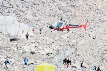  ?? — AFP file photo ?? A Nepalese rescue helicopter landing at Everest Base Camp during rescue efforts.