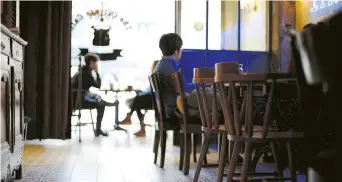  ??  ?? A young man enjoys the tranquilit­y in the Cottage Café & Bar.