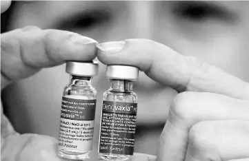  ??  ?? File photo shows Concepcion Yusop, a national immunisati­on programme manager, shows an anti-dengue vaccine Dengvaxia inside a vaccine storage room in Sta. Cruz city, Metro Manila, Philippine­s. — Reuters photo