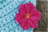  ??  ?? The bandana’s flower embellishm­ents are worked in just two quick and easy rounds