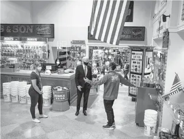  ?? DOUG MILLS/THE NEW YORK TIMES ?? President Biden speaks with Mike Siegel, co-owner of a hardware store in Washington, during a visit Tuesday to burnish public support for the relief package. The bill could be approved by Congress as early as Wednesday.