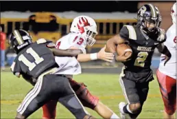  ?? Jeremy Stewart ?? Rockmart quarterbac­k Javin Whatley (2) makes a run through the middle as Sonoravill­e’s Jebb Knight (13) is wrapped up by Dennis Sims during the second quarter of Friday’s game at Rockmart High School.
