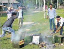  ?? PTI PHOTO ?? Unknown miscreants damage ballot boxes after snatching them from a polling booth during Panchayat elections in Malda district, West Bengal, on Monday.