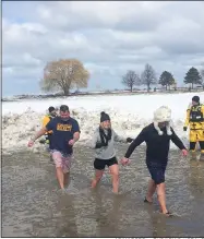  ?? ADAM DODD — THE NEWS-HERALD ?? Polar Plunge participan­ts take a dip in Lake Erie on Feb. 29.