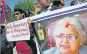  ?? AP ?? People hold up a portrait of Supreme Court Chief Justice Sushila Karki during a protest against her suspension on Monday.