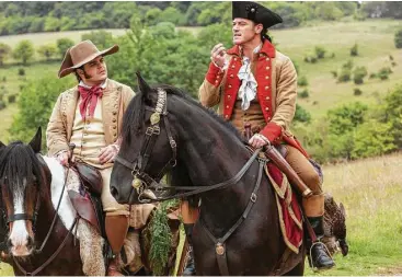  ?? Disney ?? Josh Gad, left, portrays as Le Fou, and Luke Evans is Gaston in Disney’s new live-action version of “Beauty and the Beast.” Opening nationwide March 17, it is causing a stir for a “gay” scene near the film’s end.