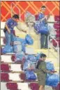  ?? GETTY ?? Japanese fans clear garbage from the stands after the match versus Germany.