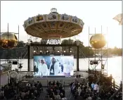  ?? FREDRIK PERSSON/TT NEWS AGENCY VIA AP ?? People look at the screen, at the ABBA Voyage event at Grona Lund, in Stockholm, Sweden, on Thursday.