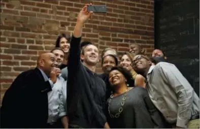  ?? JEFF ROBERSON — THE ASSOCIATED PRESS ?? Facebook CEO Mark Zuckerberg takes a selfie with a group of entreprene­urs and innovators after taking part in a roundtable discussion at Cortex Innovation Community technology hub, Thursday in St. Louis. Zuckerberg was in St. Louis to announce a...