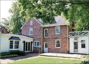  ??  ?? A family room addition off the back of the brick 2-story is designed as a recreation room with wet bar area, fireplace, bay window and patio access. The walk-up attic has been finished into 2 rooms.