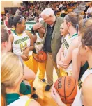  ?? STEVE HELBER/ASSOCIATED PRESS ?? In this Dec. 13 photo, West Virginia Gov.elect Jim Justice, center, talks with his Greenbrier East High team. Justice plans to keep coaching after taking office.