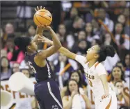  ?? Eric Gay / Associated Press ?? UConn’s Crystal Dangerfiel­d shoots over Texas’Brooke McCarty during the first half Monday in Austin, Texas.