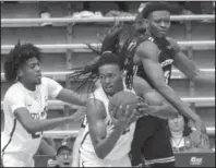  ?? Arkansas Democrat-Gazette/Mitchell Pe Masilun ?? SHOW UP AT SHOWDOWN: Little Rock forward Kris Bankston(32) comes up with the rebound Saturday ahead of teammate Horace Wyatt Jr. (25) and Central Arkansas forward S.K. Shittu(0) during the Bears’ 85-82 win at the Jack Stephens Center in Little Rock.