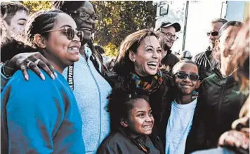  ?? JORDAN GALE/THE NEW YORK TIMES ?? Sen. Kamala Harris, D-Calif., takes a photo last October with supporters of her presidenti­al campaign in Des Moines, Iowa.