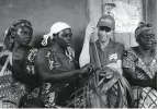  ??  ?? From top: Marta Dusseldorp with her daughters Grace and Maggie (in front) at the Congolese refugee women’s group; meeting a refugee child at Kyaka II; weaving under the guidance of Congolese refugee women at Kyaka II.