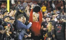  ?? Michael Macor / The Chronicle 2015 ?? Stanford head coach David Shaw holds the Pac-12 championsh­ip trophy after beating USC 41-22 at the close of the 2015 season.