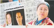  ?? JASON REDMOND / AFP / GETTY IMAGES FILES ?? A protester holds a photo of the Canadian detainees at a May court appearance for Huawei CFO Meng Wanzhou.