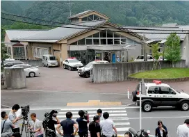  ??  ?? Journalist­s gather at the main gate of the Tsukui Yamayuri En care centre where the man went on a rampage. —