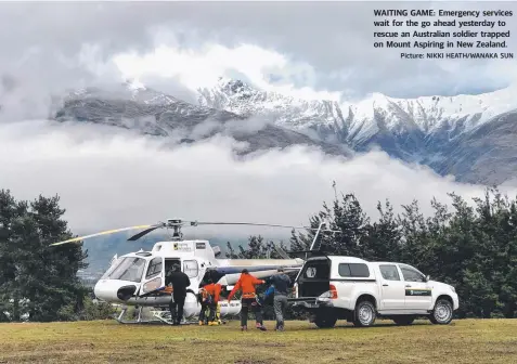  ?? Picture: NIKKI HEATH/WANAKA SUN ?? WAITING GAME: Emergency services wait for the go ahead yesterday to rescue an Australian soldier trapped on Mount Aspiring in New Zealand.