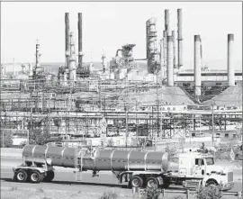  ?? Paul Sakuma
Associated Press ?? A TANKER TRUCK passes the Chevron oil refinery in Richmond, Calif. A decline in refining contribute­d to the 0.2% drop in industrial output in May.