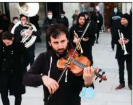  ?? (AP/Bob Edme) ?? Profession­al musicians perform Saturday on the Place of Freedom in Bayonne, southweste­rn France, wearing black in protest against a nationwide lockdown. More photos at arkansason­line. com/1129covid/.