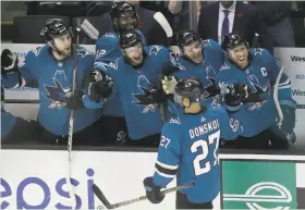  ?? Jeff Chiu / Associated Press ?? The Sharks celebrate right wing Joonas Donskoi’s score during the shootout. San Jose goalie Martin Jones stopped five of six shots in the shootout.