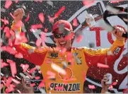  ?? AP PHOTO BY STEVE HELBER ?? Joey Logano celebrates after winning the NASCAR Cup Series auto race in Victory Lane at Richmond Internatio­nal Raceway in Richmond, Va., on Sunday.