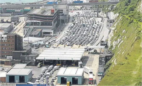  ??  ?? The jammed-up entrance to the Port of Dover as cars are backed up for miles.