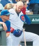  ?? JOHN J. KIM/CHICAGO TRIBUNE ?? Cubs infielder David Bote clears debris from his left eye in the dugout in the sixth inning against the White Sox at Wrigley Field on Aug. 7.