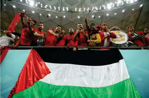  ?? (Reuters) ?? Morocco fans pose with a Palestine flag during the World Cup in Qatar last year