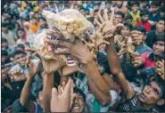  ?? AP/DAR YASIN ?? Rohingya Muslims reach for packets of biscuits Wednesday near Balukhali refugee camp in Bangladesh.