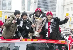  ?? CRAIG ROBERTSON / POSTMEDIA NEWS ?? From left, Toronto FC forward Sebastian Giovinco, midfielder Victor Vazquez, forward Jozy Altidore and midfielder Michael Bradley wave to the crowd during the team’s parade in Toronto on Monday.